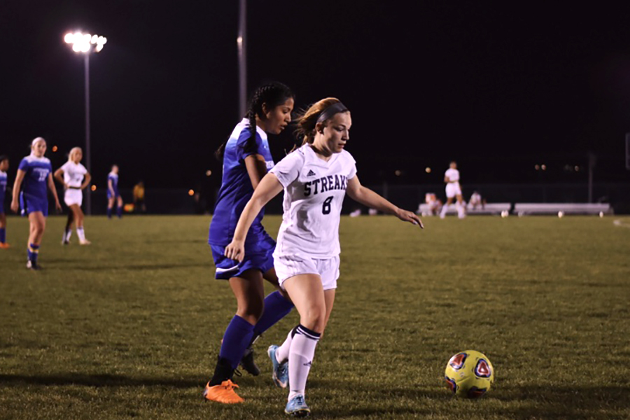Senior Mikaela O'Fallon dribbles the ball away from a defender. O'Fallon tore her ACL in October 2015 and has recovered since.