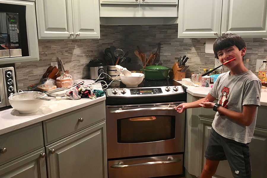 Tommy Bill points to the mess created from baking. Baking may have made a mess of the kitchen, but the satisfaction after finishing was worth all of the dishes that had to be done afterward.