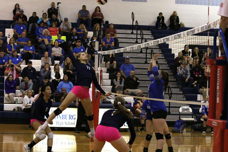 Sophomore Amelia Mitchell gets ready to spike the ball over the net.
