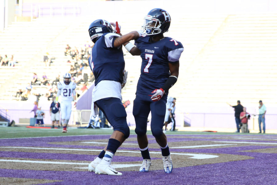 Junior Jahiem Anderson and senior Marcus Robinson-Jenkins celebrate a touchdown.