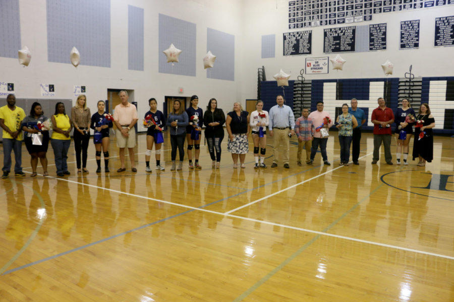 All the seniors and their families stand in front of the crowd after being recognized. 