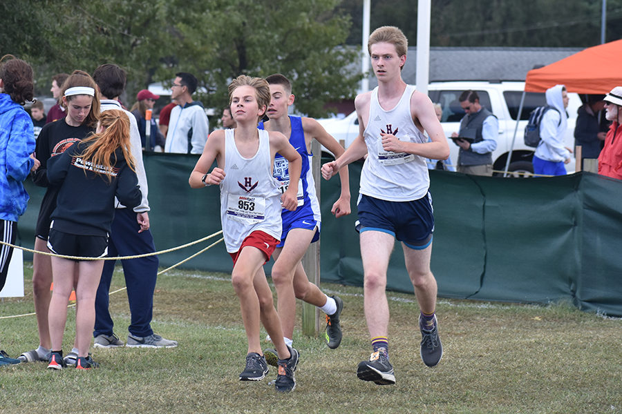 Freshman Owen Johnston and junior Michael Hulleman come around a corner after the first mile mark.