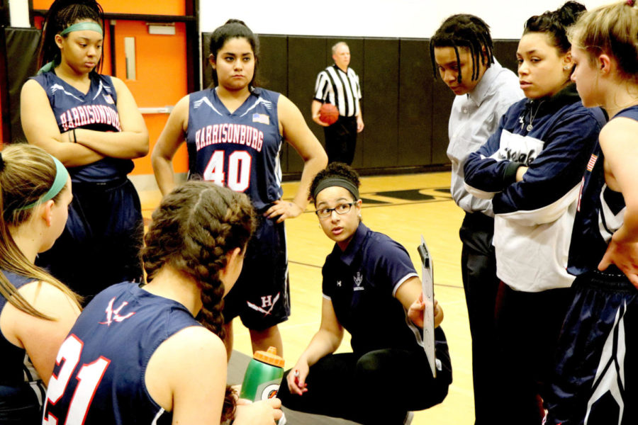 Coach Allysia Rohlehr talks to the JV girls basketball team during a time out in the second quarter of a game at Charlottesville.  