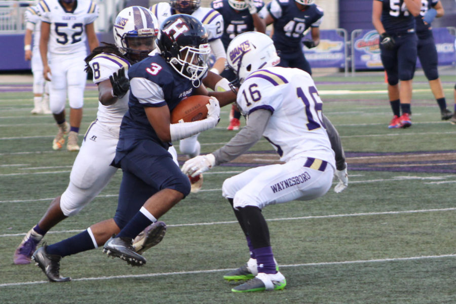 Senior Victor Lynch evades Waynesboro High School defenders after catching a punt.