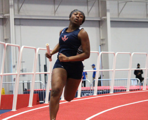 Senior Aaliyah Jordan sprints around the curve during her leg of the 4x200 meter relay at the Liberty Premier Invitational on Jan. 13.