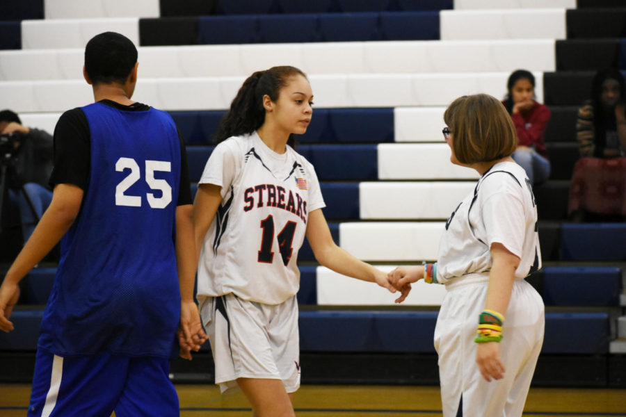 Freshman Mariah Cane (left) guides Ella Schminkey Ward across the court.