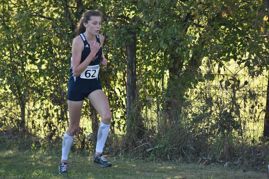 Freshman Kate Kirwan runs the Girls Varsity Race at the Regional meet. Kirwan placed 23rd out of 65 runners. 