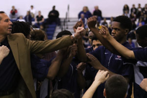 The Streaks huddle during a timeout as head coach Don Burgess speaks.  