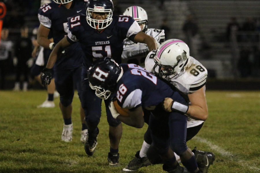 Sophomore Dunstan Williams is dragged down by a Turner Ashby defender on a run play.