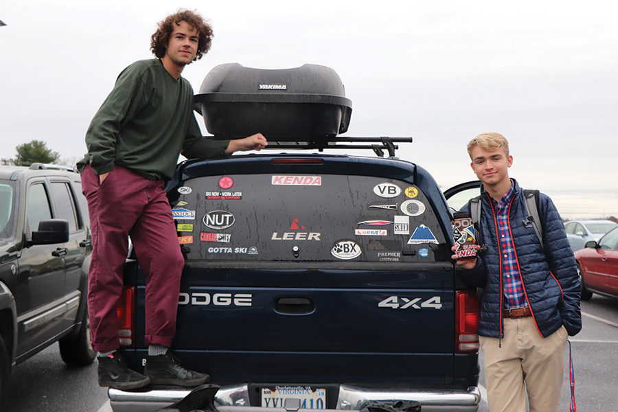 Senior Walker Thompson (right) stands next to his truck with senior John Collier. Walker collects stickers from places he has travelled.