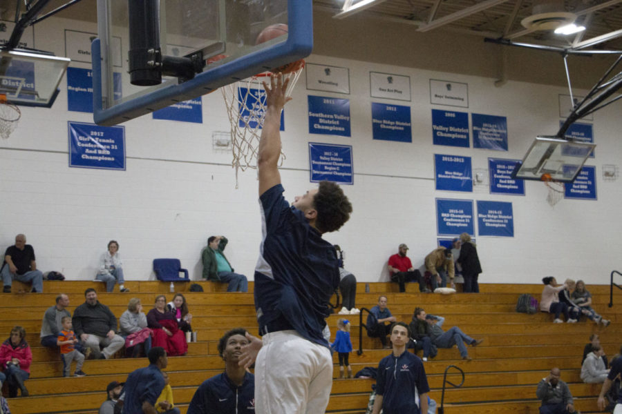 Junior Dshawn Fields goes up for a layup during warmups before the game. 