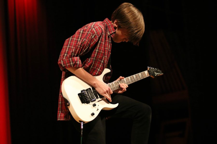 Senior Aerious Kubin riffs his solo guitar part as the last act of the show.