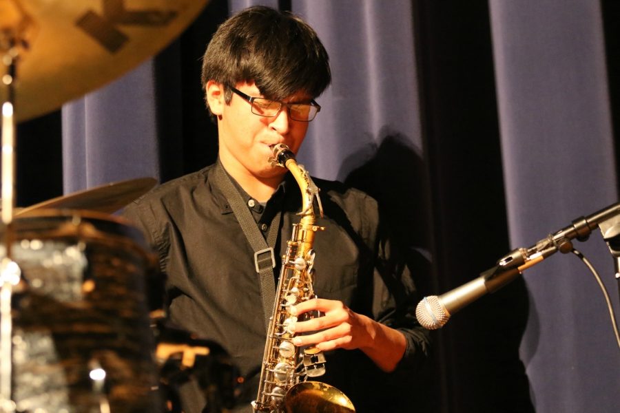 Junior Kelvin Lopez plays the saxophone, accompanied by senior drumming companion Alison Munoz.