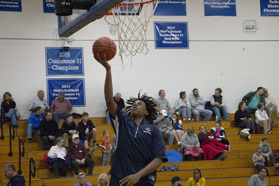 Sophomore Jazen Walker goes up for a layup during warmups. 