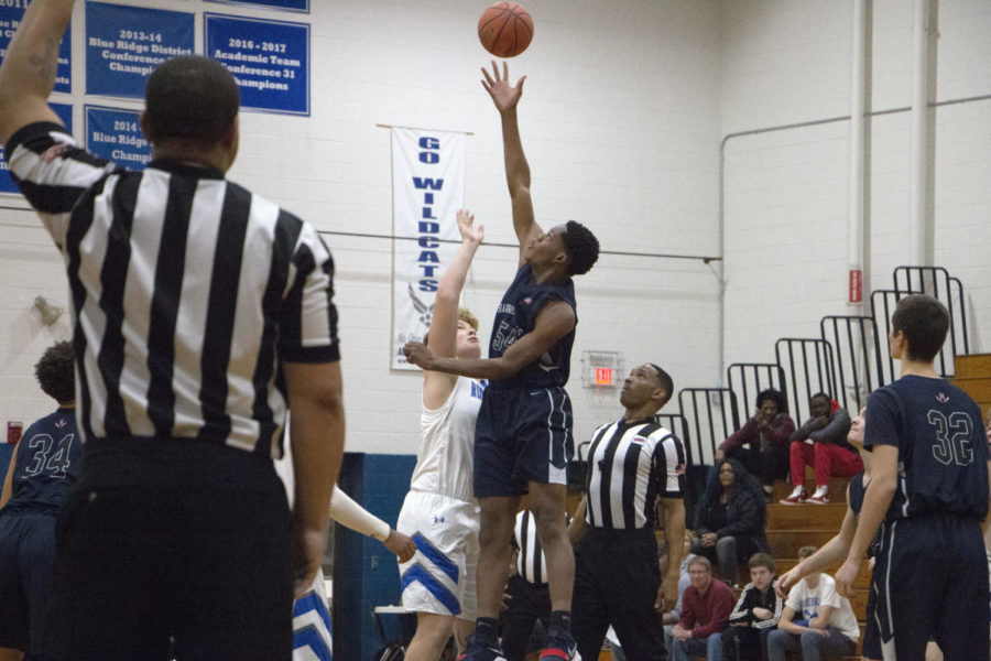 Junior Micheal Kuangu goes up during the initial tip off. 