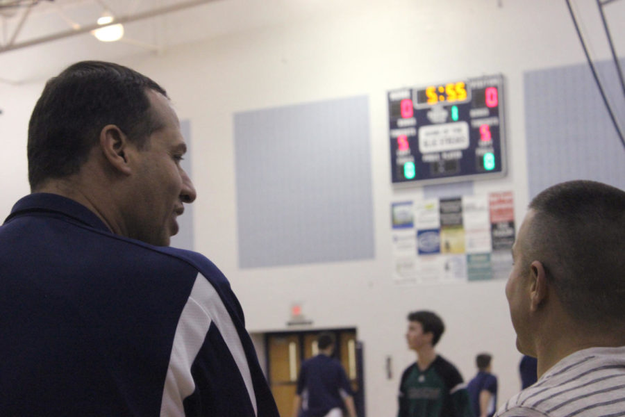 Coach Burgess speaks with a HHS supporter as the teams warm up.