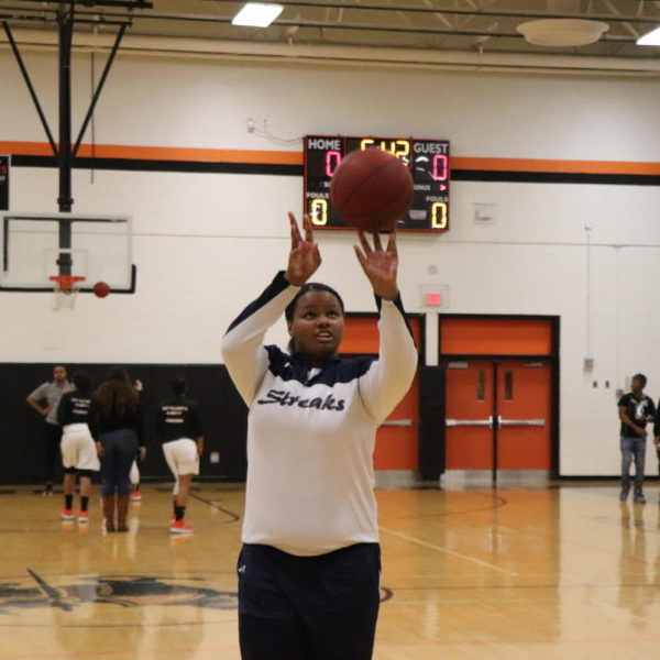 Sophomore Nisha Farmer shoots a free throw during warmups prior to the Streaks game.