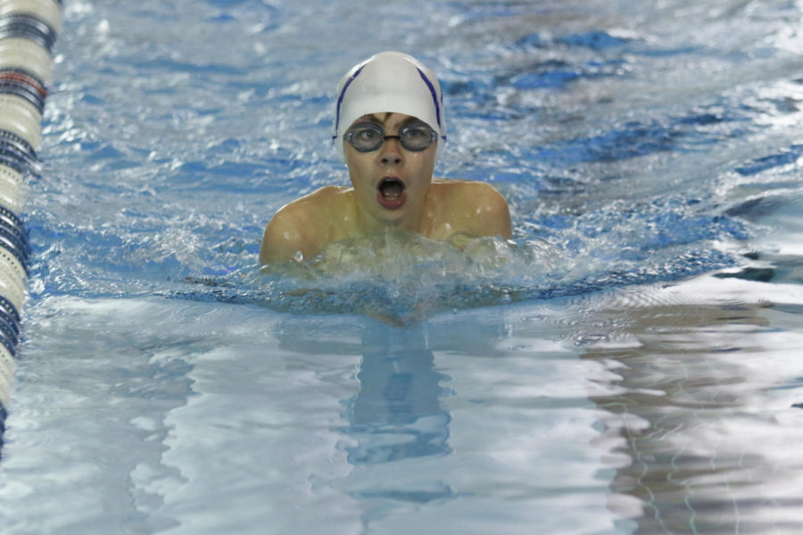 Freshman Owen Johnston swims in the 100 yard breaststroke. 