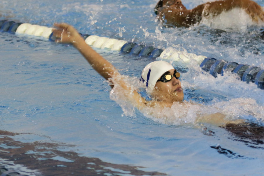 Sophomore Stanley Inouye swims in the 100 yard backstroke event. 