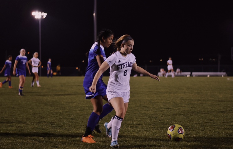 Senior Mikaela O'Fallon wins the ball during a game in her junior season. After tearing her ACL three times, O'Fallon was able to return to soccer each time and recently committed to continue her career at the University of Mary Washington.