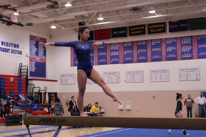 Sophomore Ruby Arndt does a full turn on beam.