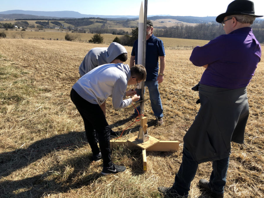 Sophomores Thomas Shulgan and Seth Fernandez are working on hooking up their rocket to the launch pad. They are being supervised by STEM Engineering teacher Andy Jackson and mentor Dr. Pyle.