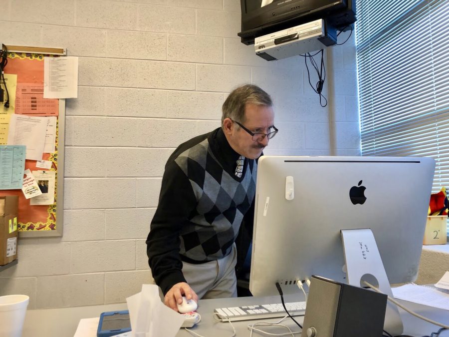 Spanish teacher Henry Garcia prepares his lesson for class. Before going into his teaching career, Garcia practiced law for 15 years in Colombia, later immigrating to the United States, where he now teachers AP Spanish at the school. 