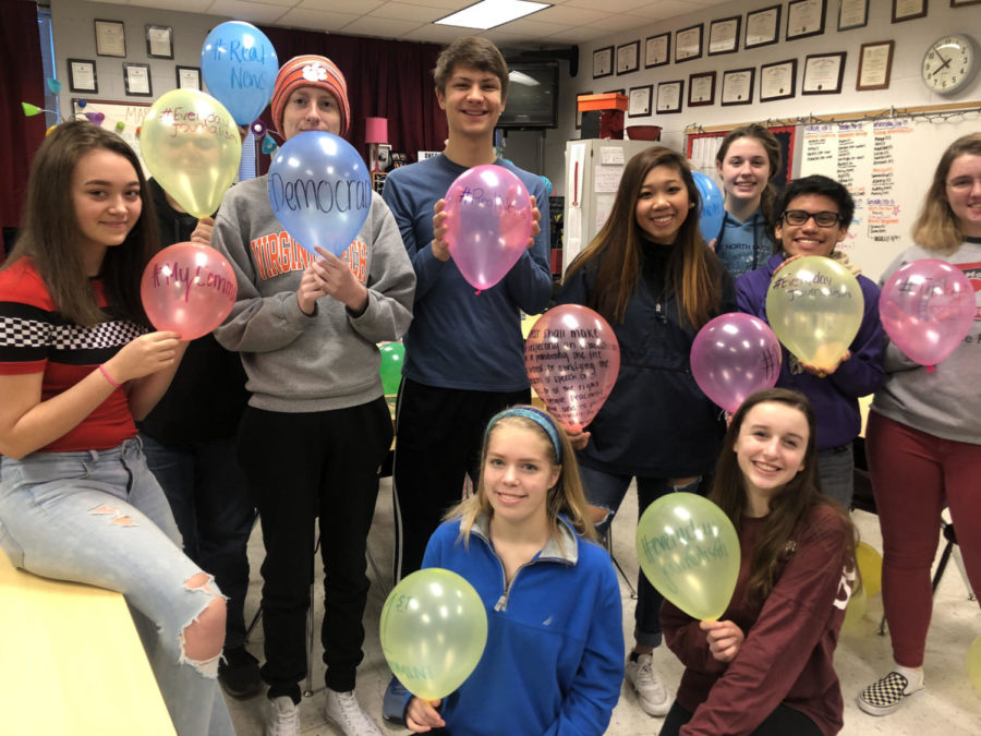 Students in Newsstreak hold up balloons commemorating the First Amendment.