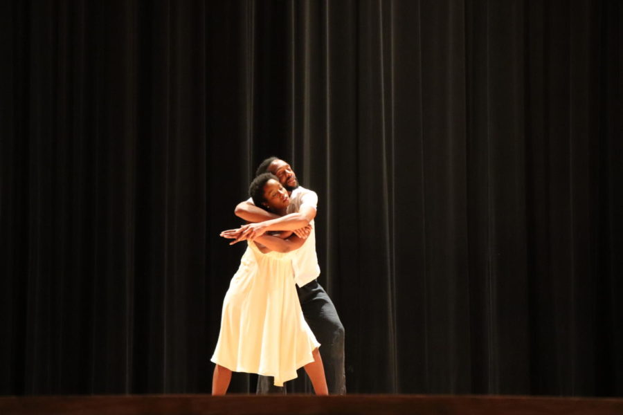Two dancers move intertwined.