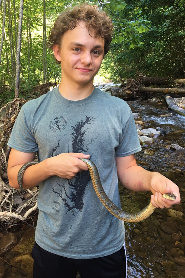 Sophomore Jonas Miller holds a snake. He has been interested in herpetology, the study of reptiles and amphibians, from a young age.