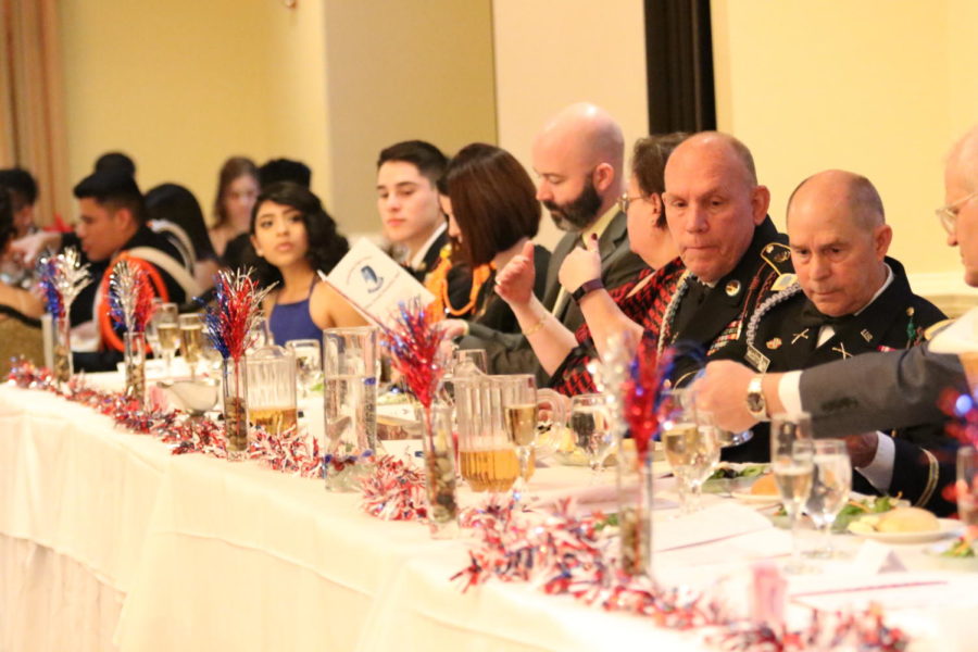 Sergeant Major Russell Wilder (second to right) and Colonel Roy McCutcheon (right) lead the front table at the annual JROTC cadet ball at the Spotswood Country Club in 2019. 