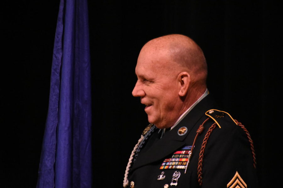 Sergeant Major Russel Wilder smiles as he watches students receive awards. 