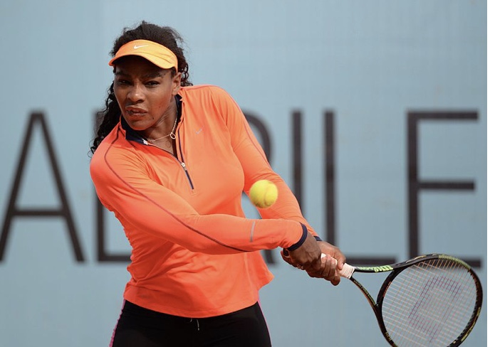 Tennis player Serena Williams serves up the ball at one of her tennis matches. Williams is a professional tennis player who recently released an ad focused around female athletes through Nike. 