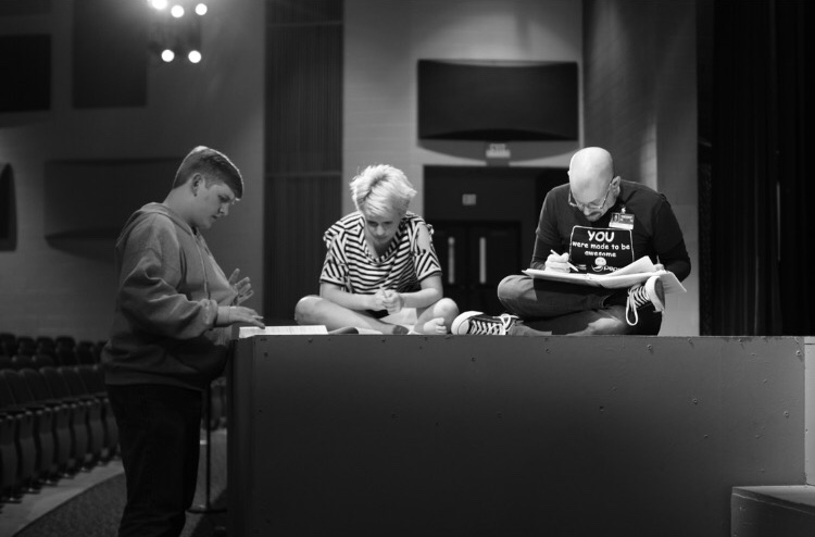 Librarian Bradley Walton (right) works with seniors Ray Walton (middle) and Kyle Showalter (left) during a script rehearsal from a past spring play. This years play is based on the LGBTQ+ community written by Walton. 