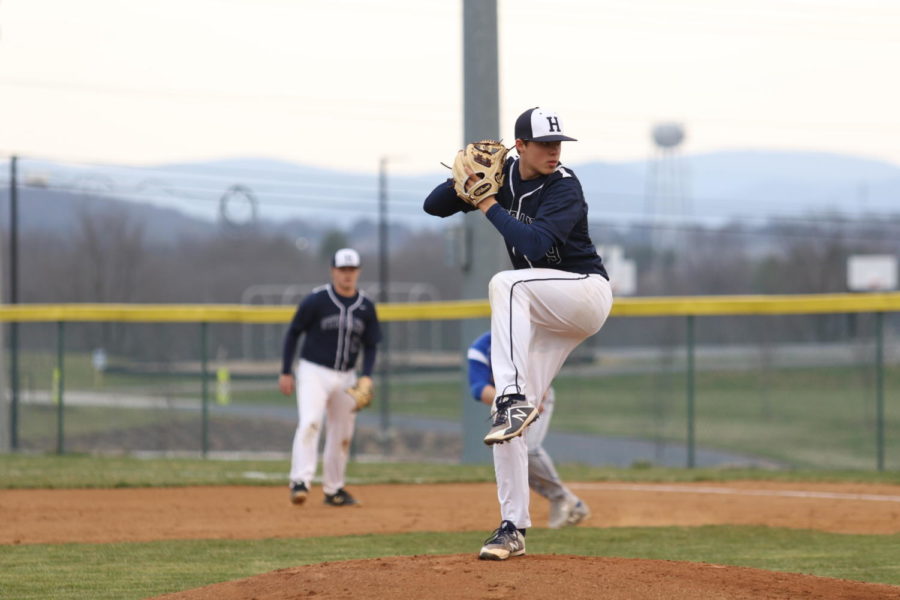 Freshman Evan Burt winds up to deliver a pitch.