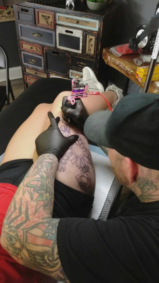An artists at Tattooed in the Wild Studio works on Hughes tattoo.  