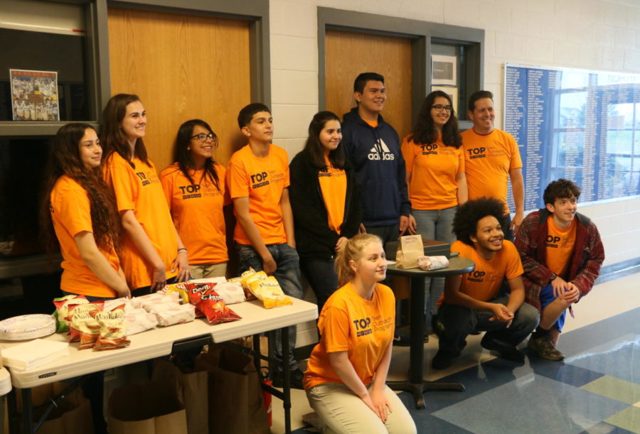 Members of the On the Road apprenticeship program pose for a photo, while standing near the concessions that they brought in for the movie night.