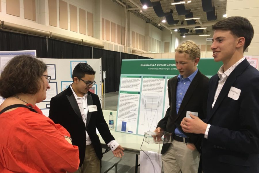 (From left to right) Freshmen Mikey Paniagua, Micah Tongen and Keenan Glago present at the Virginia State Science and Engineering Fair in Roanoke. After three and a half hours of interviewing by judges, the public came to view the different projects. 