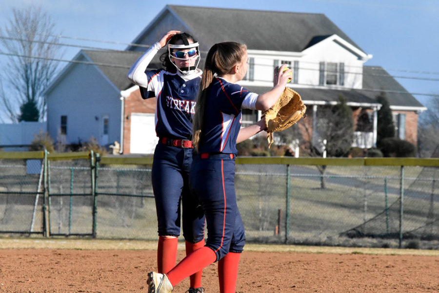 Sophomores Karleigh Gentry and Alyssa Sutton communicate on the field.