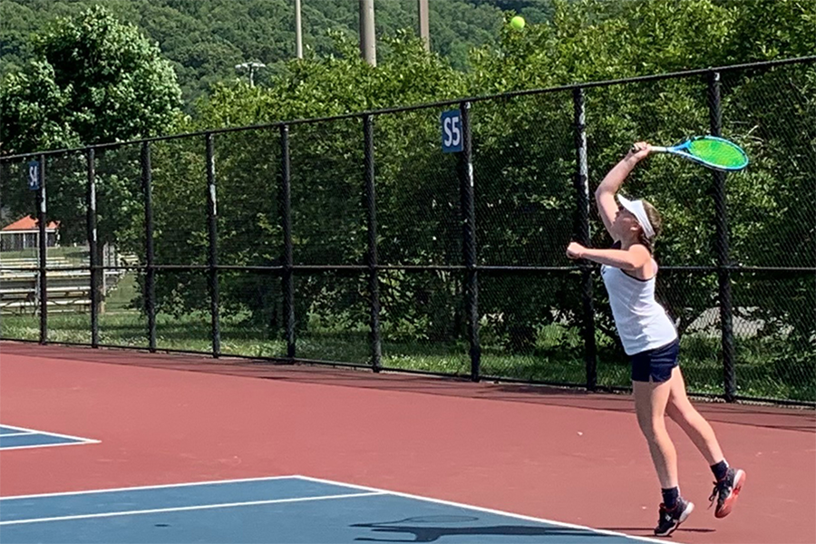 Senior Andrea Osinkosky serves the ball.