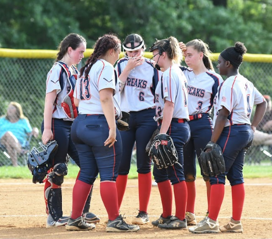 Infielders talk to their starting pitcher senior Hannah Brown during an away game at Rockbridge County High School prior to the start of the inning.