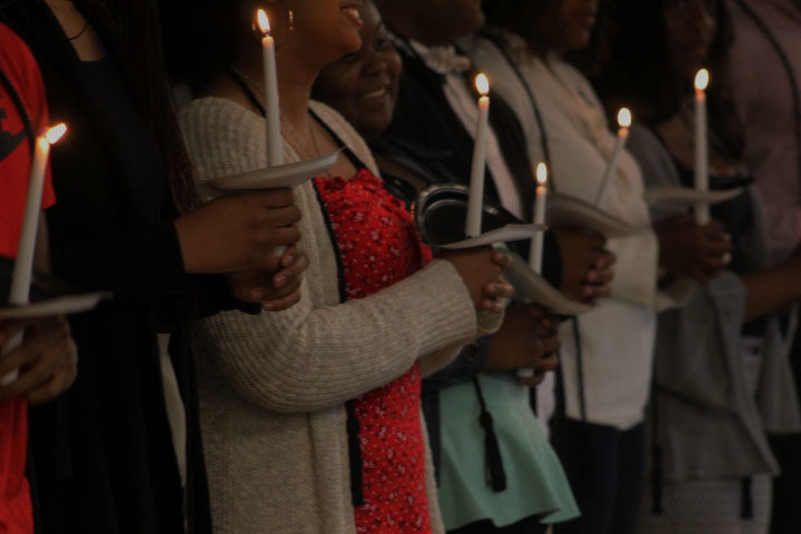BSU senior members hold lit candles as right of passage for the next part of their lives.