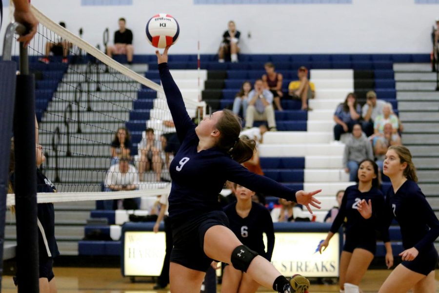 Sophomore Hope Persinger jumps up to tip the ball over the net. 