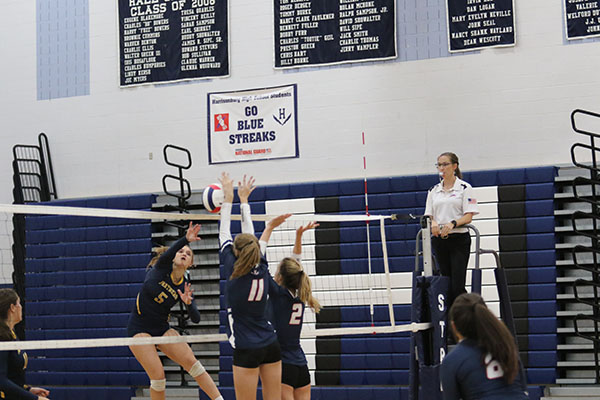 Junior Amelia Mitchell (left) and Ellie Hammond go up for a block.