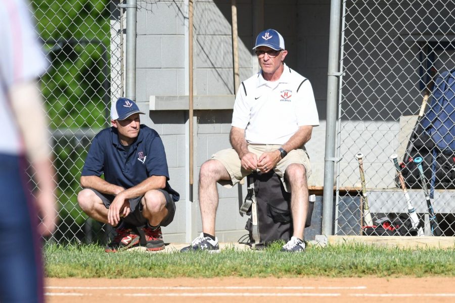 Coaches Carter Holden (left) and Randy Hill (right) watch the varsity softball players play defense during an away game at Rockbridge County High School last season. 