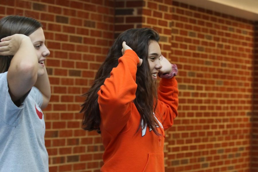 Sophomores Julienne Butler and Ellie Muncy film a TikTok, while doing a popular dance to the Mariah Carey song "Obsessed."