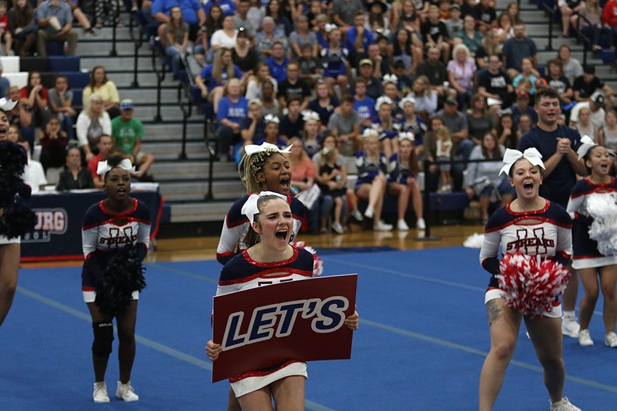 Junior Lizzy Healy participates in involving the crowd in a cheer.