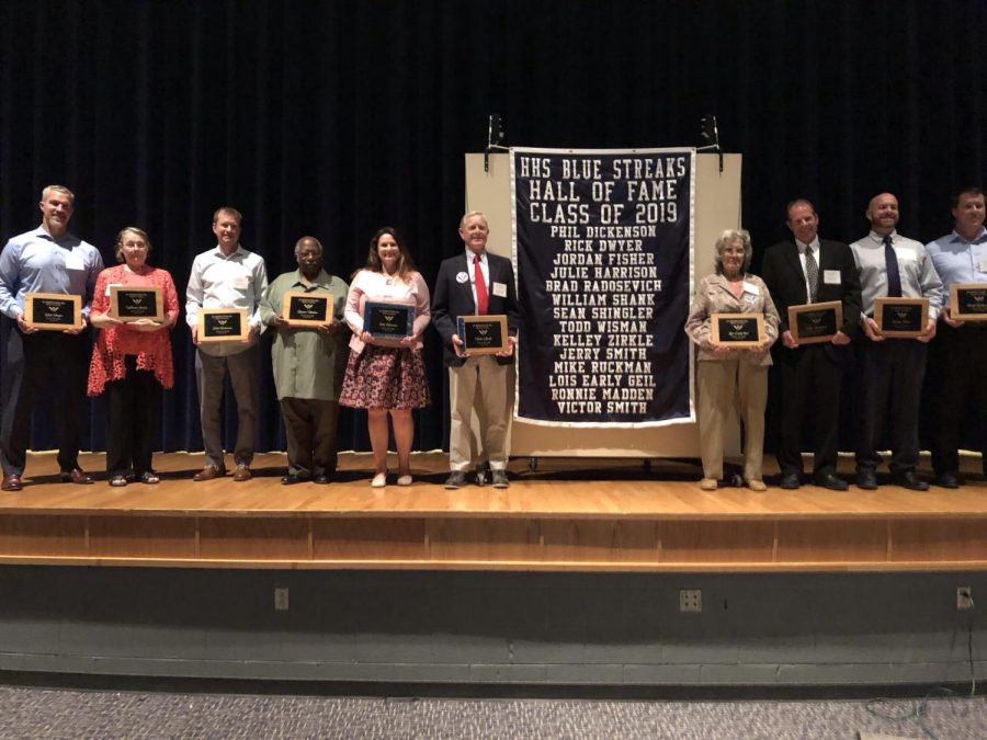 Members of the Hall of Fame class of 2019 receive their plaques made from the old football stadium.