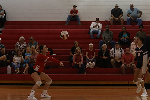 Senior Abby McCollum passes the ball up so it can get killed.
