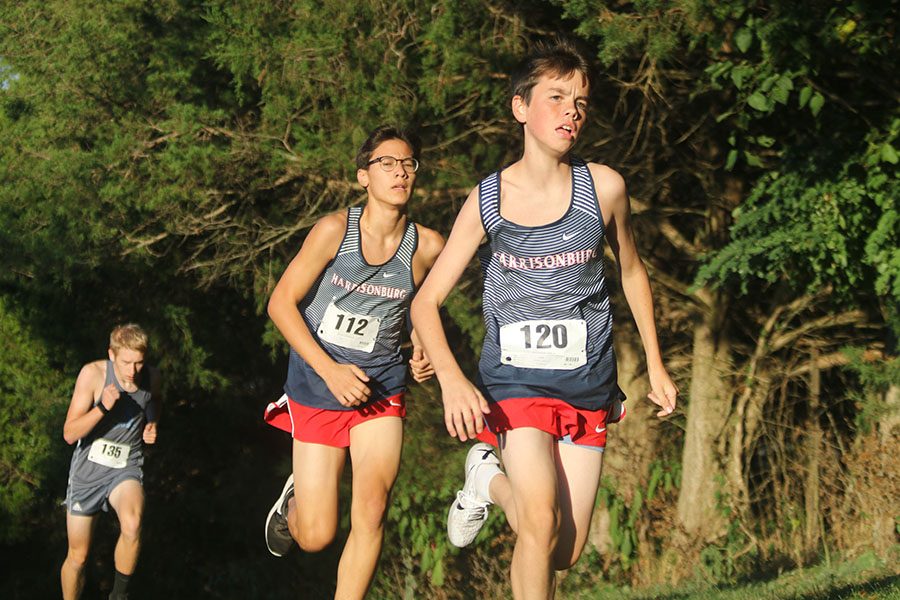 Running up The Wall, freshmen Aidan Sanders and Trevor Inouye compete side by side in the boys JV race. 
